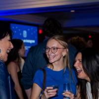 Two grads smile talking with Philly